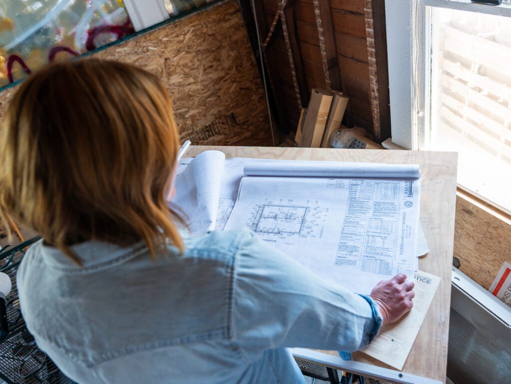 Femal construction project manager on a jobsite examining plans