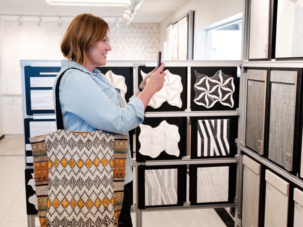 Courtney Murphy taking a picture of tiles at Arizona Tile showroom.